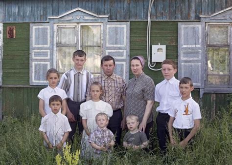 A family of ten stands in front of their old house, which will be ...