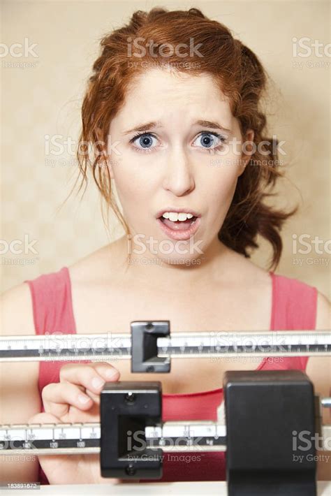 Young Woman On A Scale And Concerned Stock Photo - Download Image Now - Adult, Adults Only ...
