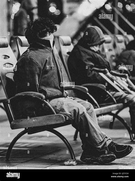 A grayscale shot of homeless people at the station in Kyiv at night Stock Photo - Alamy