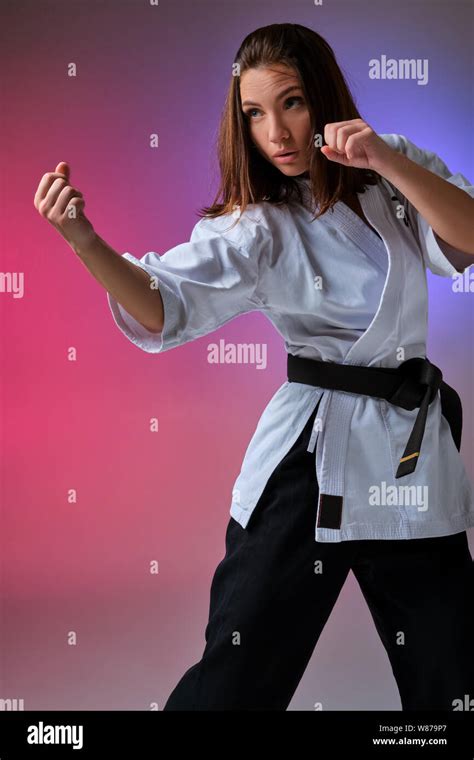 Athletic woman in traditional kimono is practicing karate in studio Stock Photo - Alamy