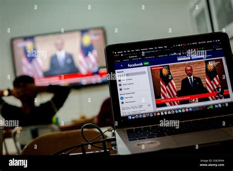 Prime Minister Muhyiddin Yassin's speech on a laptop screen in Kuala ...