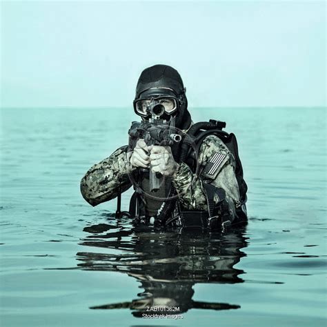 Navy SEAL frogman with complete diving gear and weapons in the water. | Stocktrek Images