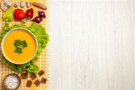 Free Photo | Top view of pumpkin soup with vegetables on white