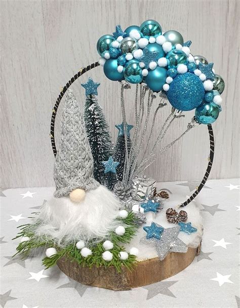 a table topped with blue and white decorations on top of a wooden slice ...