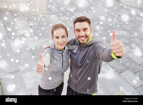 couple of sportsmen showing thumbs up outdoors Stock Photo - Alamy