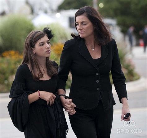 two women walking down the street holding hands