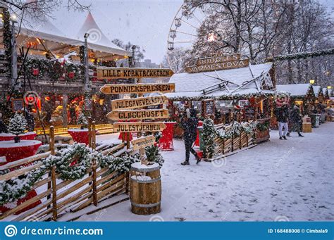 Photo about Traditional Christmas market with falling snow, Oslo, Norway. Image of christmas ...