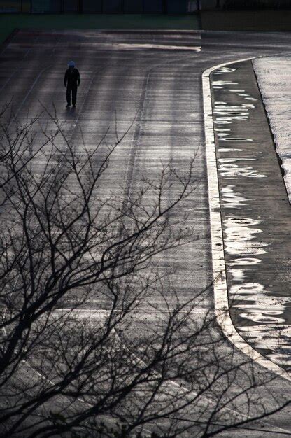 Premium Photo | Silhouette person walking on street in city