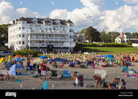 The Union Bluff Hotel in York, Maine, with sunbathers on the beach ...