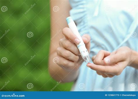 Woman using lancet pen stock image. Image of hypoglycemia - 123861773