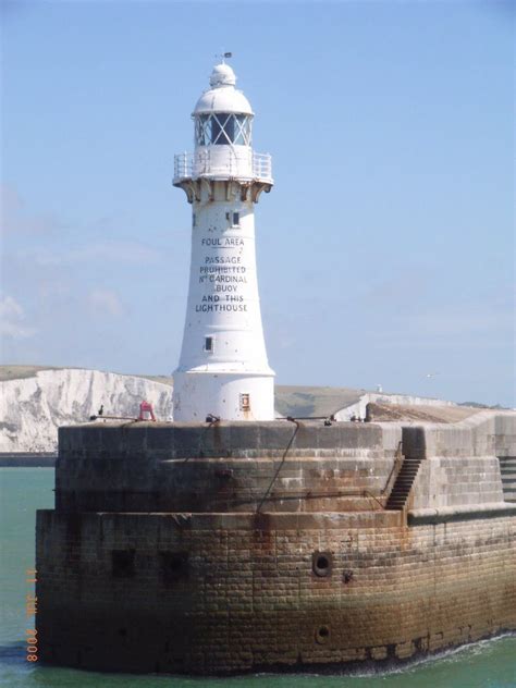 Dover Admiralty Pier Lighthouse in Dover, Kent, England. Behind the lighthouse you can see The ...