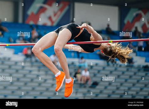 young woman jumper high jump in summer athletics championships, fosbury flop technique Stock ...