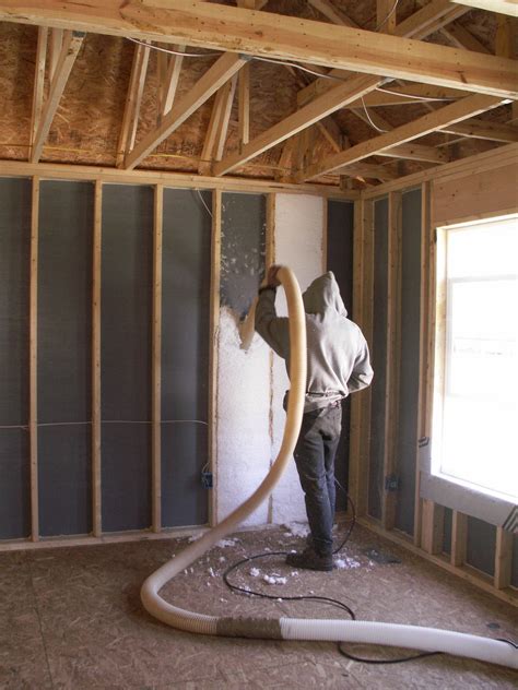 Blown fiberglass insulation fills netted wall cavities | Building ...