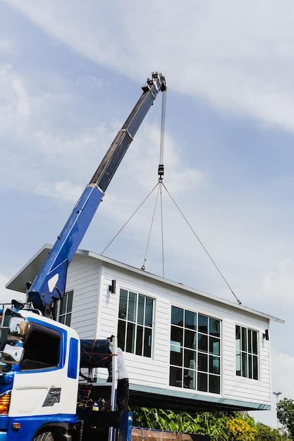 Premium Photo | Crane lifting a knock down private house