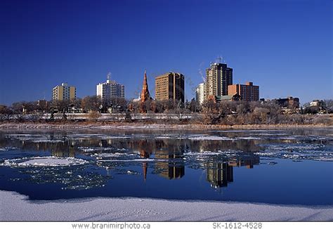 Image: Saskatoon skyline reflecting in South Saskatchewan River, Saskatchewan