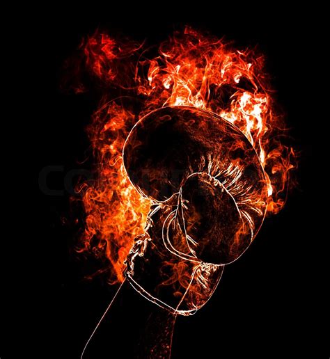 Red punching boxing glove in fire isolated on dark | Stock image | Colourbox