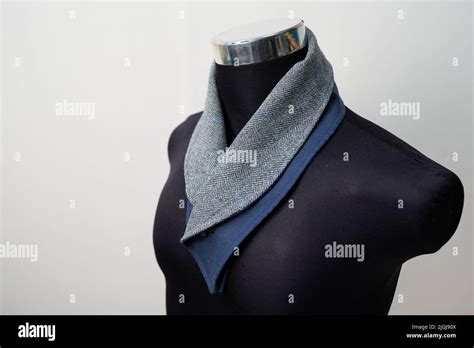 Black mannequin with gray and blue scarf for formal wear, turtleneck style Stock Photo - Alamy