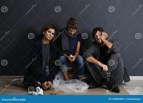 Poor Homeless Family Sitting on Floor Stock Photo - Image of background ...