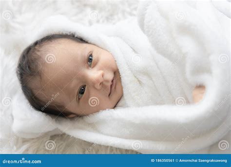 Portrait of Cute Newborn Baby Looking Eye Contact and Smiling on White Bed Stock Image - Image ...