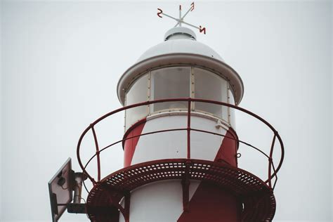 Beacon of lighthouse against cloudy sky · Free Stock Photo