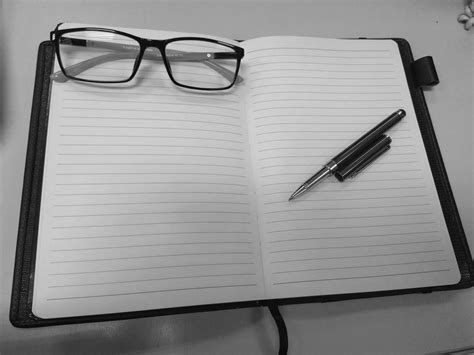 Glasses and pen on lined notebook free image download