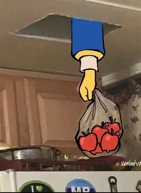 a bag full of tomatoes hanging from the ceiling in a kitchen with cabinets and cupboards