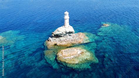 Aerial drone bird's eye view of iconic lighthouse of Tourlitis in port ...