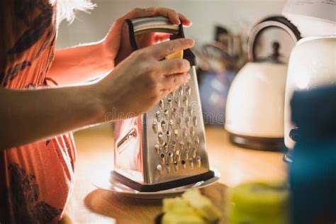 Grating cheese with grater stock photo. Image of home - 180942500