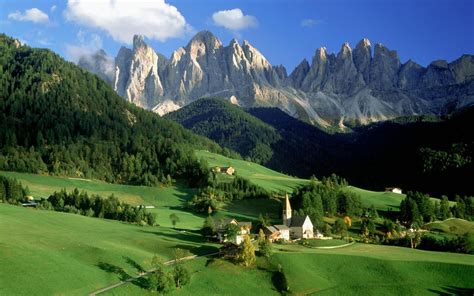 Austrian Alps Peaks Range Of Rock Fields With Grass Green Mountain Village House Church Sky With ...