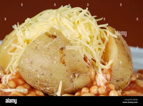 Jacket potato with cheese and beans Stock Photo - Alamy