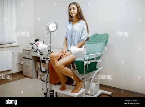 Woman sitting on the gynecological chair before a medical examination ...