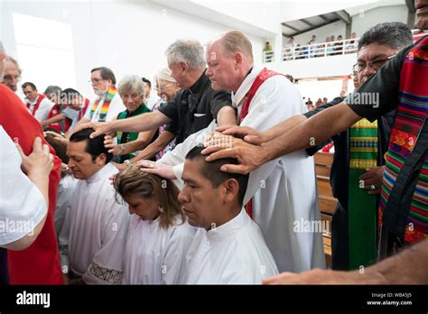 Traditional laying on of hands blessing during ordination ceremony for Lutheran seminarians and ...