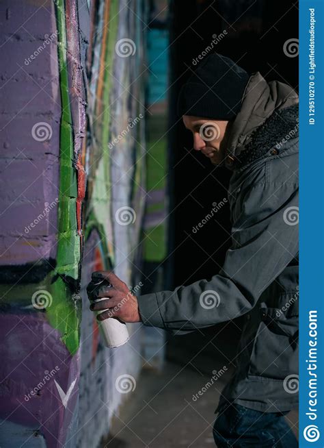 Street Artist Painting Graffiti with Aerosol Paint on Wall Stock Photo ...