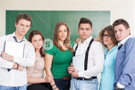 A group of boys and girls in a school classroom posing Royalty-Free Stock Image - Storyblocks