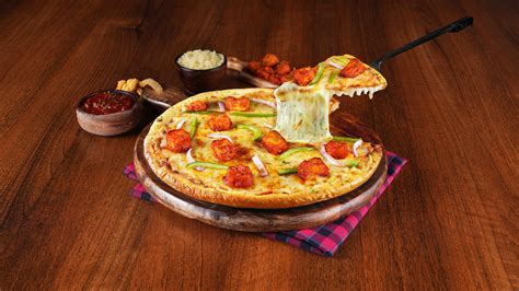 Order Schezwan Paneer Cheese Burst Pizza Medium online from Ovenstory