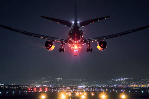 Download Hd Plane Landing At Night Wallpaper | Wallpapers.com