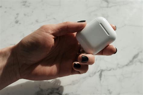 Close-Up Photo of Person Holding Airpods Casing · Free Stock Photo