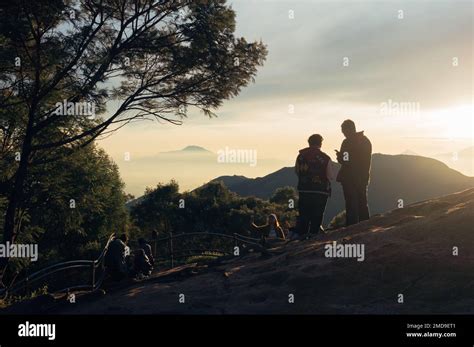 Banjarnegara, Indonesia - January 21, 2023: Tourists stand after hiking to the peak of Sikunir ...