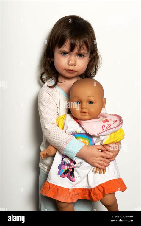 2-year old girl holding doll Stock Photo - Alamy