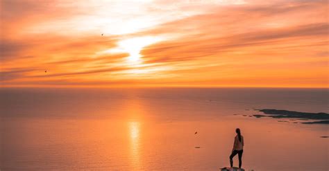 Man Standing On Cliff During Sunset · Free Stock Photo