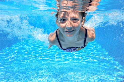 Happy active underwater child swims in pool 788226 Stock Photo at Vecteezy