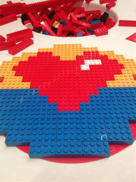 legos laid out on a table with red, yellow and blue blocks in the shape ...