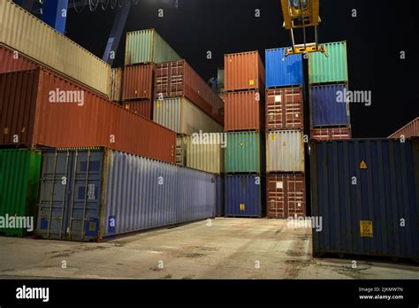 operation of container terminal at night. Unloading container ship at night. Mooring cranes ...