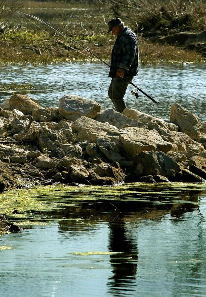 A fisherman walks from his fishing spot | StateImpact Texas