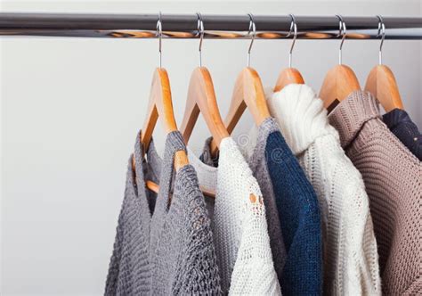 Different Knitted Sweaters on Hangers Close-up Stock Photo - Image of cloth, autumn: 122088946