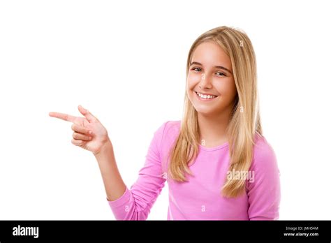 Attractive young girl pointing her finger. White background Stock Photo ...