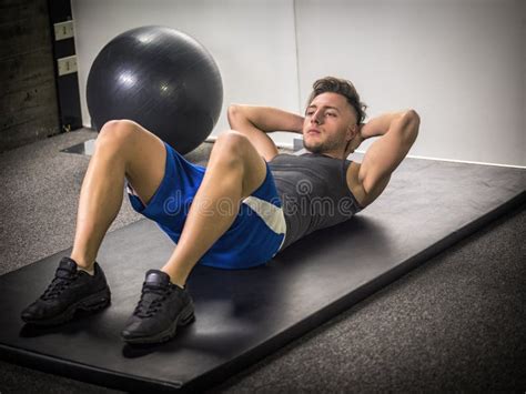 Handsome Young Man Doing Abs Exercises on Mat Stock Image - Image of single, muscle: 137616923