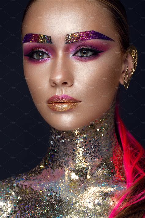 Beautiful girl with creative glitter makeup, sparkles, unusual eyebrows. Beauty is an art face ...