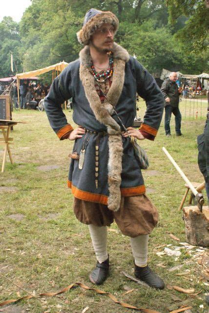 a man dressed in an old fashioned outfit with fur on his head, standing ...