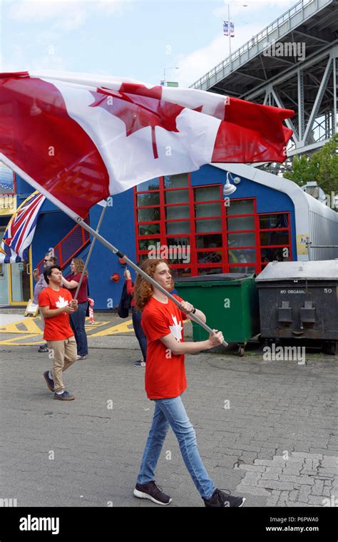 A young man waves the Canadian flag in the annual Canada Day Parade on ...